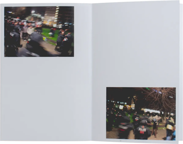 Open book. Layout shows two photos. The photos are taken at night and are slightly blurry. We can see people in black and red uniforms, presumably police officers. 