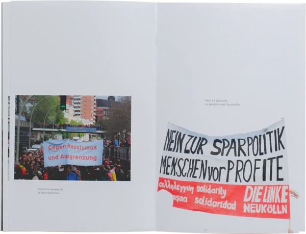 Open book. Layout of a photo from a protest in Europe, and an isolated protest banner which read in German 